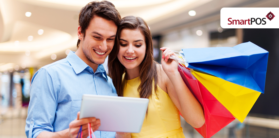 A couple purchasing products online and making the payments via a POS system