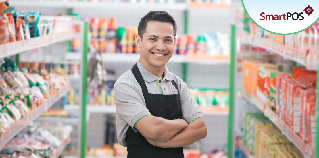 An employee who uses our cloud-based POS software smiles with his arms folded