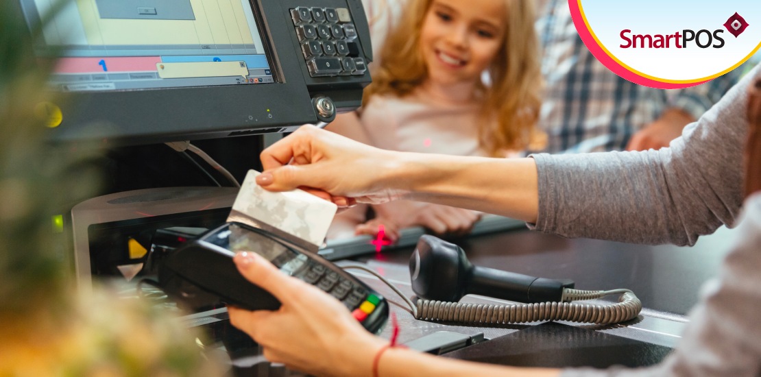 A customer watches a speciality POS software solution in operation